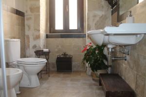 a bathroom with a sink and a toilet at Casa Giacchino in Noto