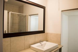 a bathroom with a sink and a mirror at 722 at 66 Keerom Street in Cape Town +4 photos