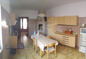 una cocina con mesa y una cocina con mesa y sillas en Appartamento vacanza Salento, en Parabita