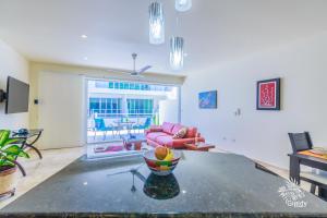 a living room with a couch and a bowl of fruit at Estrella del Mar - Condo 101 in Isla Mujeres
