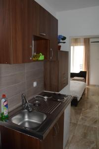 a kitchen with a sink and a bed in a room at Studios Seaview in Dobra Voda +57 photos