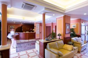 a living room with two couches and a kitchen at Vald Hotel in Val Della Torre