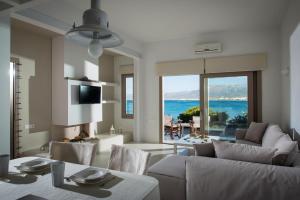 a living room with a view of the ocean at Villa Asterias in Stalida
