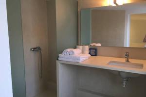 a bathroom with a sink and a mirror at Villa Asterias in Stalida