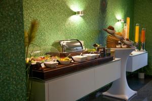 a buffet line with dishes of food on a table at Aragon - Hotel - Garni in Tangermünde