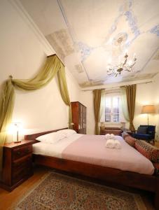 a bedroom with a bed with two towels on it at Petrizio Palace in Zadar