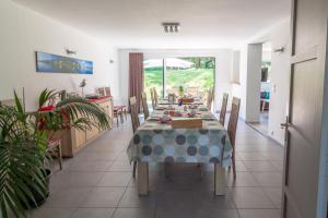 a dining room with a table with a blue and gray table cloth at Chambres du Bout du Monde in Landévennec