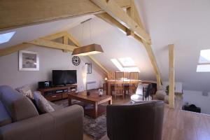 a living room with a couch and a table at Appartement Barcelonnette in Barcelonnette