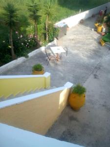a view of a patio with a table and plants at Chrysanthi Melitsa apts. in Sidari