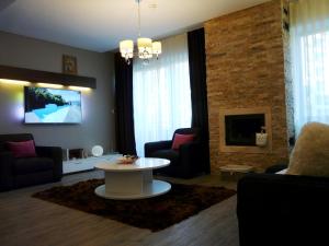 a living room with a couch and a table and a tv at Silver Mountain Apartment A32 - 3 rooms 3 bathrooms in Poiana Brasov