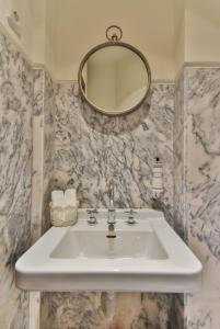 a bathroom with a sink and a mirror at Republica 157 Guest House in Porto +65 photos