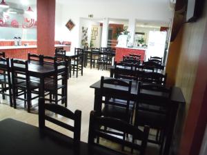 a row of tables and chairs in a restaurant at Hotel Basilio Reformado pelo SBT in Mongaguá