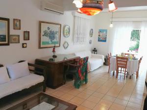 a living room with a couch and a table at Μaisonette Deja Bleu in Syvota
