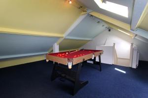a ping pong table in a room in a attic at 81 Eastgate in Cowbridge