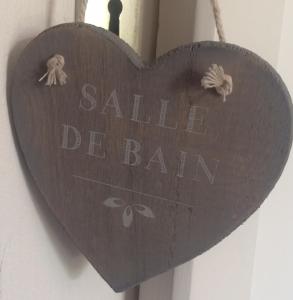 um coração de madeira com as palavras saliva beamedamedamedamed celeiro em Chambres Les Passiflores em Saint-Palais-sur-Mer