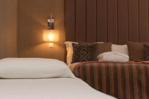 Cama ou camas em um quarto em Your Hotel & Spa Alcobaça
