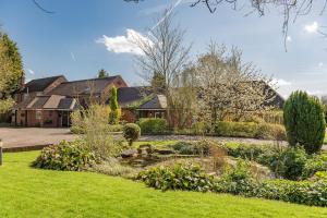 a garden in front of a house at Brook Marston Farm Hotel in Sutton Coldfield