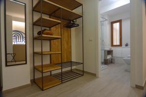 a bathroom with a shelf in the middle of a room at Il Rifugio Dei Templari in Lecce