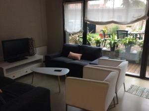 a living room with a couch and chairs and a tv at Hotel Viaurelia in Montblanc