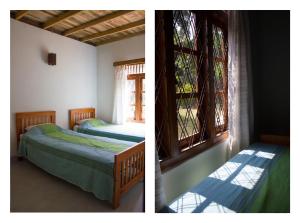 two beds in a room with a window at The Pepper Cottage in Gomagoda