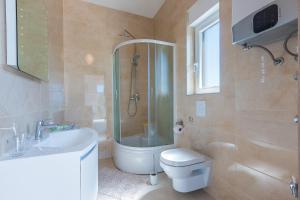 a bathroom with a toilet and a sink and a shower at Guesthouse Bencun Medulin in Medulin +35 photos