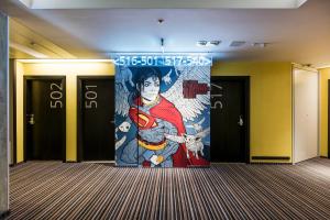 a mural of a superhero on the wall of a hallway at Comfort Hotel LT - Rock 'n' Roll Vilnius in Vilnius