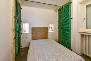 En eller flere senge i et værelse på Apartment Attico panoramico di Martina Franca