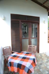 a porch with a table and two chairs and a window at Holiday Home Bentota in Bentota +38 photos