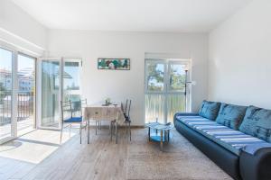 a living room with a blue couch and a table at Guesthouse Bencun Medulin in Medulin