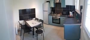 a small kitchen with a table and chairs in it at Boost Your Immo La Courtaude T3 N in Six-Fours-les-Plages