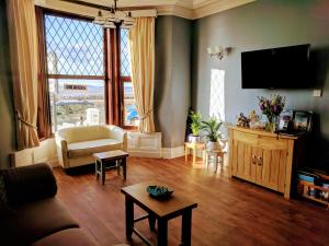 a living room with a couch and a tv at Craigwell in Morecambe