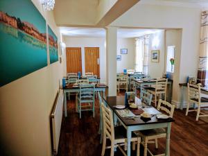 a restaurant with tables and chairs in a room at Craigwell in Morecambe