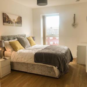 a bedroom with a large bed and a window at City Centre Apartment in Portsmouth