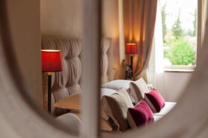 a reflection of a bedroom with a bed with pillows at Locanda I Girasoli in Misano Adriatico