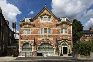 an old brick building with a large window at One Warwick Park Hotel in Royal Tunbridge Wells