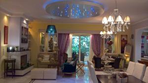 sala de estar con sofá y lámpara de araña en Primavera Holiday Home, en Vrachati
