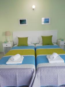 two beds sitting next to each other in a bedroom at Ocean Blue Apartments in Paphos