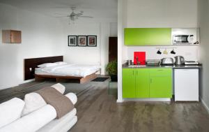 a living room with a green cabinet and a bed at G38 Rental Apartment Building in Haifa