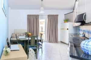a kitchen and living room with a table and a dining room at Agora Apartment in Limenas