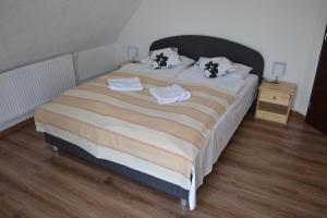 a bedroom with a large bed with two pillows at Velická izba in Poprad