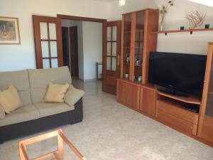 a living room with a couch and a flat screen tv at ApartamentosFinisterre in Finisterre