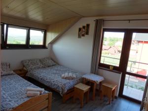 a room with two beds and a table and windows at u Skiby in Krajno Pierwsze +26 photos
