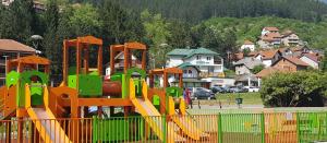 a playground with a slide in a park at Vila Zlatar in Nova Varoš