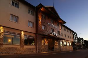a large building with a clock on the side of it at Hotel Tres Reyes in San Carlos de Bariloche
