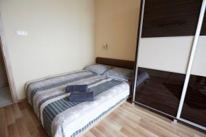 a small bedroom with a bed with blue towels on it at Prémium Home in Pécs