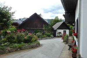 a courtyard of a house with flowers and plants at Turistična kmetija Žerovc in Bled