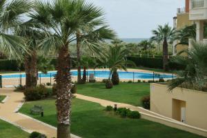 a view of a resort with a pool and palm trees at Las Dunas by HOMA in Isla del Moral