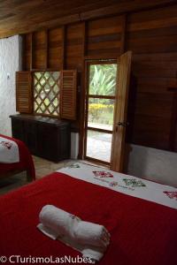 Ένα ή περισσότερα κρεβάτια σε δωμάτιο στο Ecolodge Las Nubes Chiapas