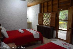 Un pat sau paturi într-o cameră la Ecolodge Las Nubes Chiapas