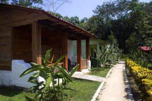 a house with a pathway next to a building at Ecolodge Las Nubes Chiapas in La Fortuna Gallo Giro